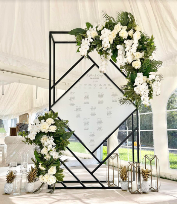 6ft statement table plan backdrop with florals pieces. Showstopping Backdrops for your events.